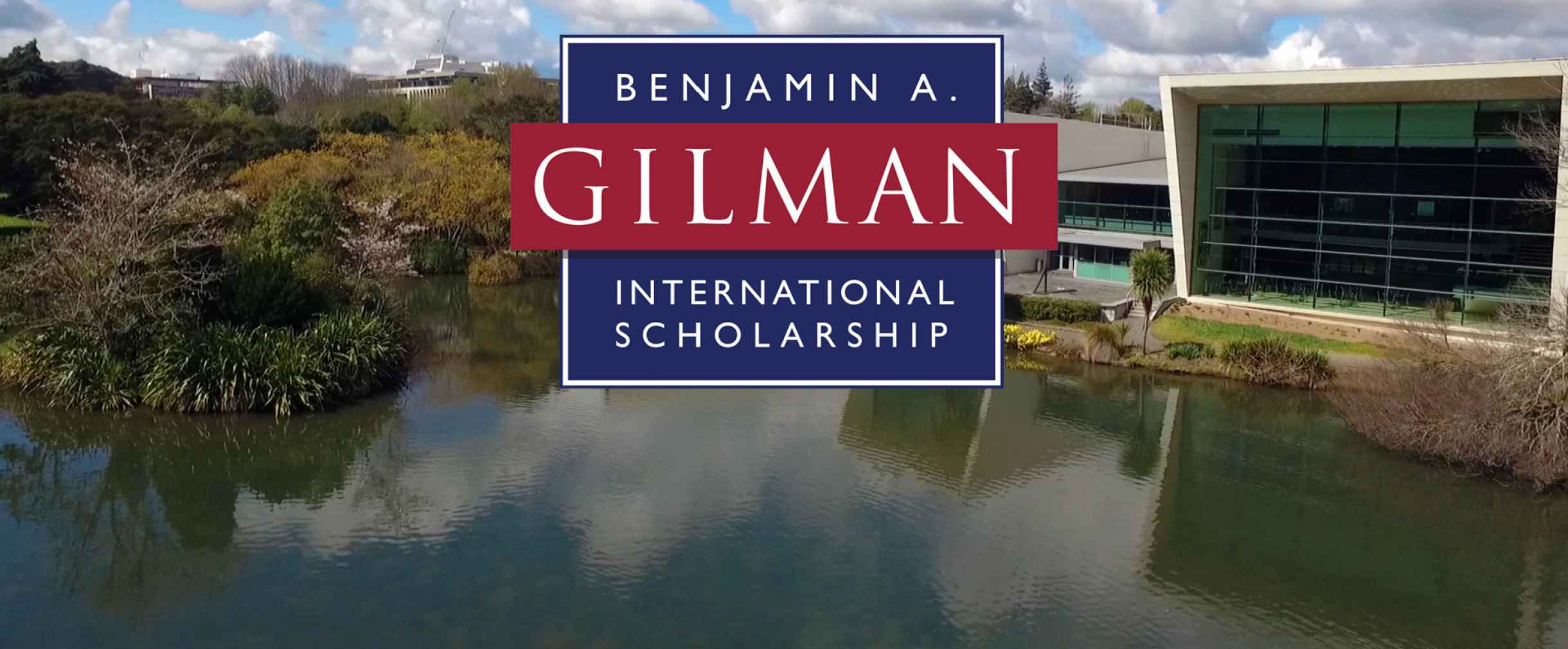 Background contains a lake with buildings along the shore and foreground contains the logo for Benjamin A. Gilman International Scholarship